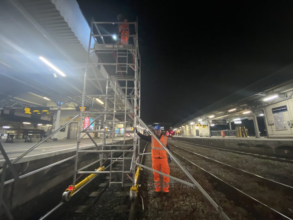 Operatives assembling a mobile access tower on the track at Bristol Temple Meads railway station